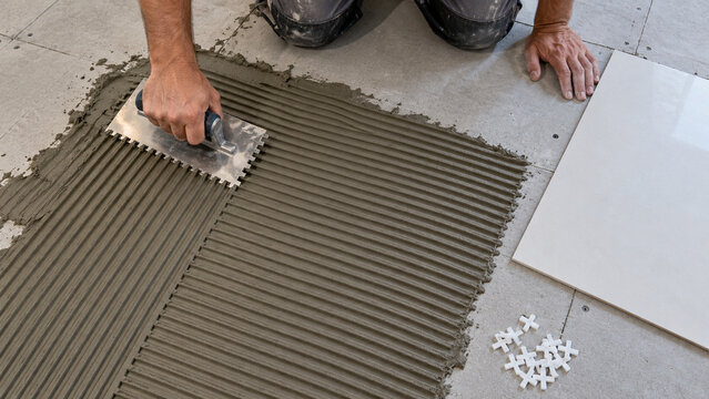 Tile Setter Spreading Thinset With Notched Trowel