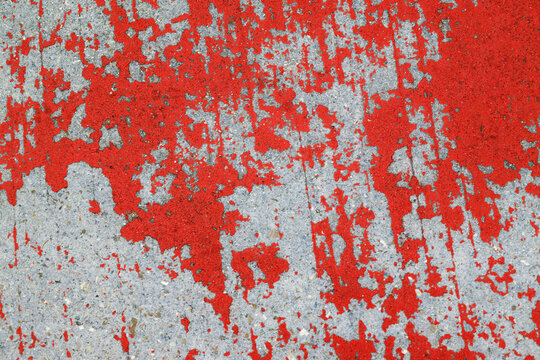 Paint peeling on concrete surface.