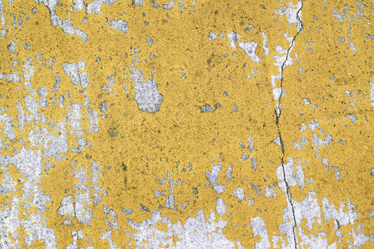 Paint peeling on concrete surface.