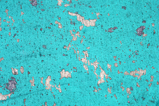 Paint peeling on concrete surface.