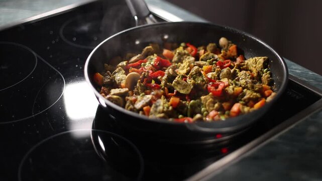 Colorful vegetable mix with soy pieces are cooked in a pan