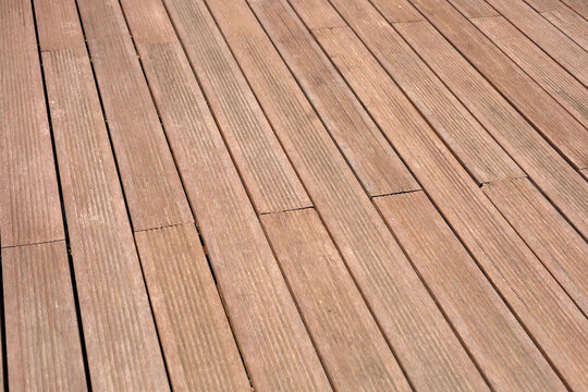 Dark brown composite wooden deck flooring planks.