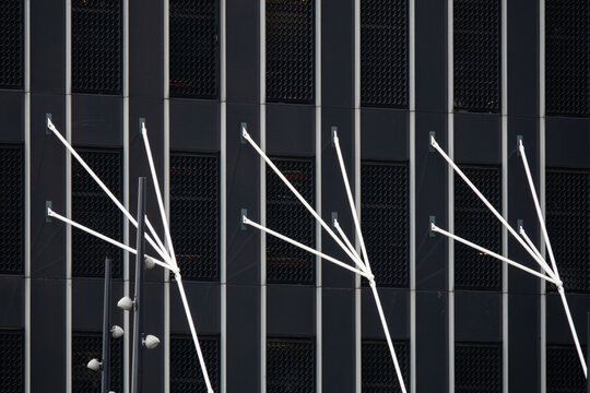 View of the modern dark facade of a building featuring white structural cables and grid patterns in Rotterdam, South Holland, Netherlands.