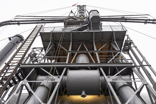 View of the historic industrial crane at Leuvehaven with its complex metal framework, ladders, and pipes in Rotterdam, South Holland, Netherlands.