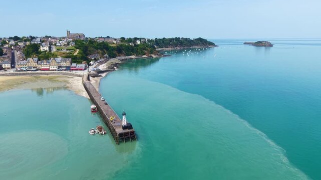 Aerial view of the picturesque fishing village of Cancale on the Emerald Coast. The picture shows the Port de la Houle harbour area at low tide with the distinctive Cale de l'&Eacute;pi pier. The row of ho