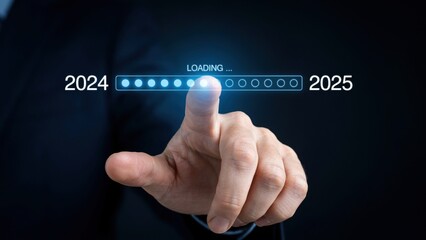Obraz premium Hand touching digital loading bar transitioning between years 2024 and 2025