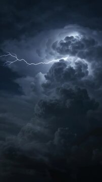 Dramatic lightning strikes through stormy clouds in vertical format during a nighttime tempest