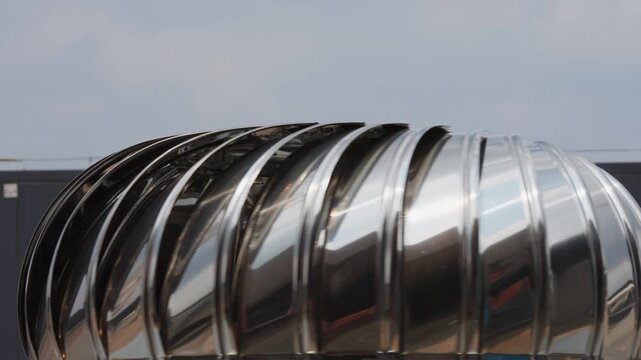 Close-up of stainless steel turbine hood with rotating blades for exhaust ventilation