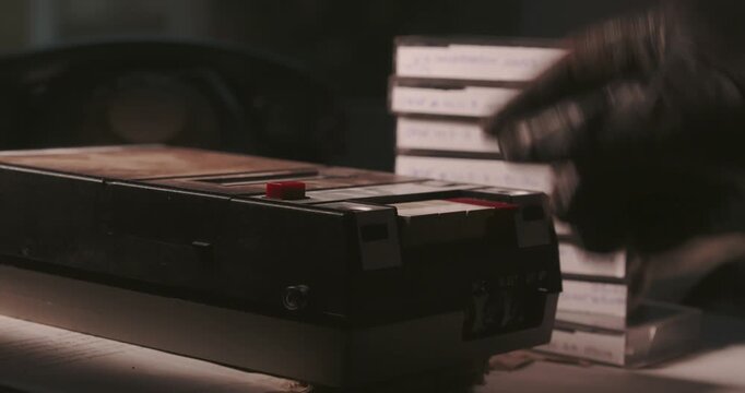 Macro pan across a retro cassette recorder with analogue tapes on a detective desk, creating a cinematic visual of archived true crime case evidence.