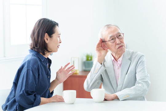 難聴の高齢者に大声で話をする女性