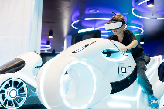 Immersive virtual reality gaming experience with a young woman using a VR headset and futuristic simulator, showcasing interactive entertainment, digital technology and next-generation gaming.