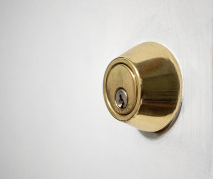 Metal brass door knob entry lock open house white door