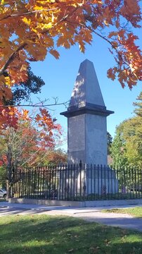 Historic Revolutionary War Monument Framed by Vibrant Autumn Leaves in Lexington Massachusetts