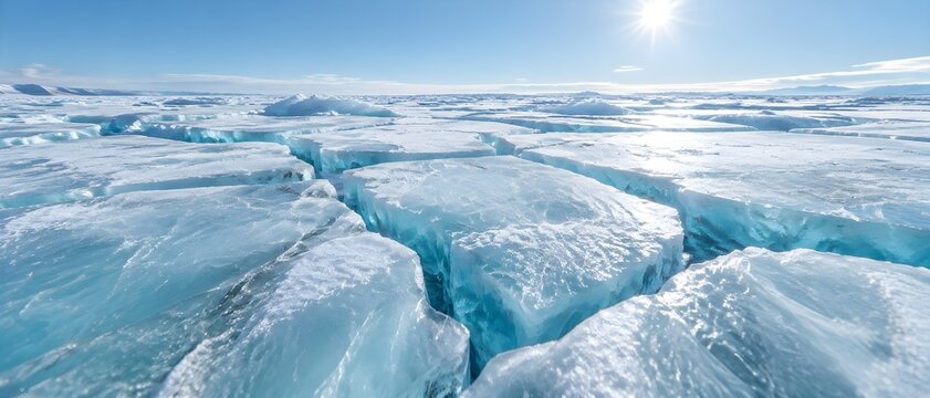 Expansive cracked glacier ice field stretching under pale winter sky