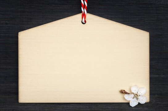 Blank wooden ema prayer plaque with red cord and plum blossom