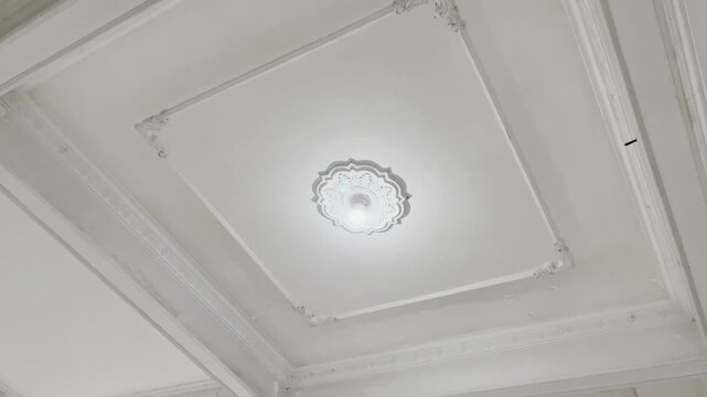 Decorative plaster ceiling molding with elegant hanging lamp