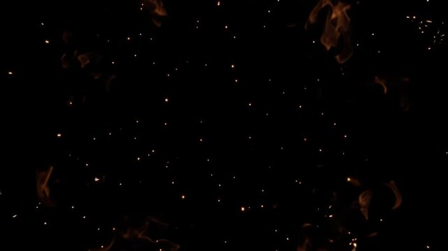 A vibrant golden explosion of light and sparks bursts against a solid black background, seamless looping video overlay.