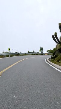Winding Mountain Highway through Misty Highlands Seen from a Moving Car. Vehicle POV. Vertical Video.