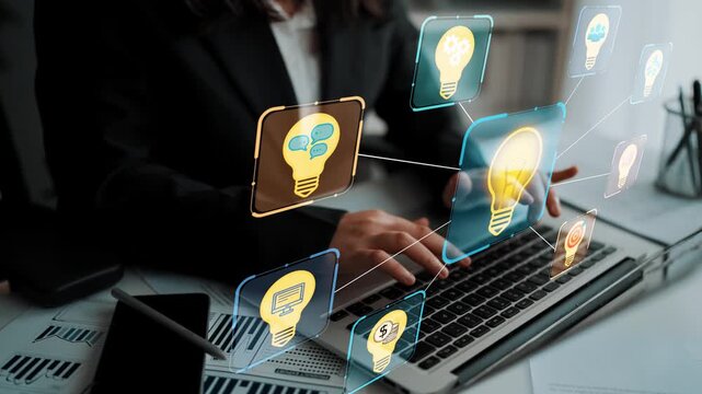 Concept of innovative thinking and business strategy with digital light bulbs and interconnected ideas while using a laptop in a professional setting. Entropy.