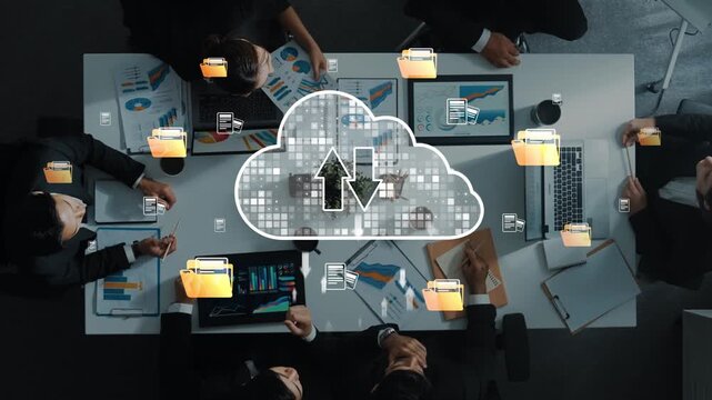 A diverse team engages in cloud computing during a business meeting, exchanging data ideas and collaborating through laptops in a modern office environment. Raster