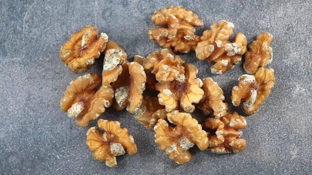mold walnuts are displayed on a gray surface.
