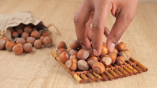 Gathering hazelnuts on a wooden surface in a kitchen setting