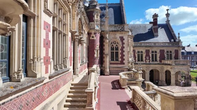 Palais B&eacute;n&eacute;dictine courtyard with carved stone urns, decorative balustrades, ornate facade and slate roofs in F&eacute;camp, Normandy, France