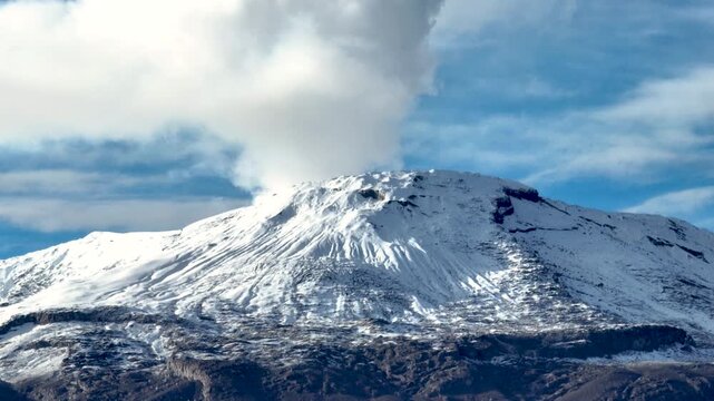 Nevado del Ruiz Volcano Covered with Snow above the Andean Highlands in Colombia. Aerial View.