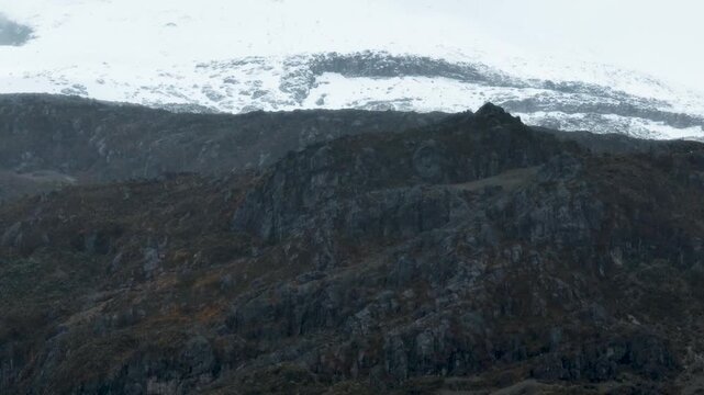 Nevado del Ruiz Snow Covered Volcanic Slopes in the Colombian Andes. Establishing Shot. Aerial View.