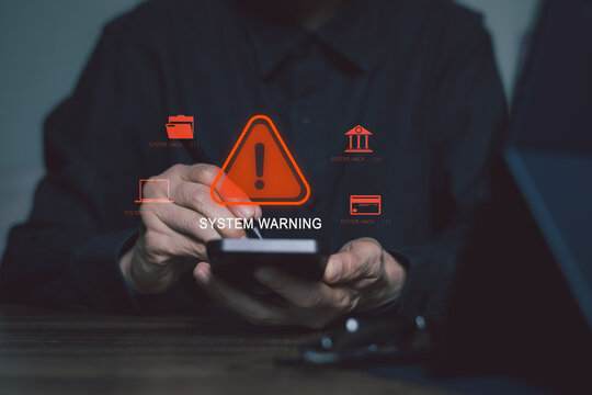 Cybersecurity warning concept showing a user holding a smartphone with a system alert, cyber attack and data breach icons, highlighting digital security, online threats and network protection.