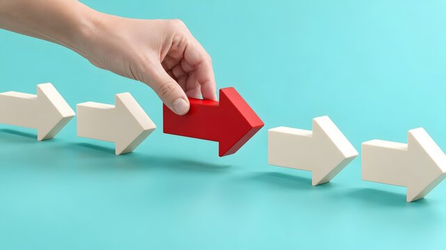 Hand placing a red arrow in a row of white arrows representing strategic leadership unique choice and workflow optimization