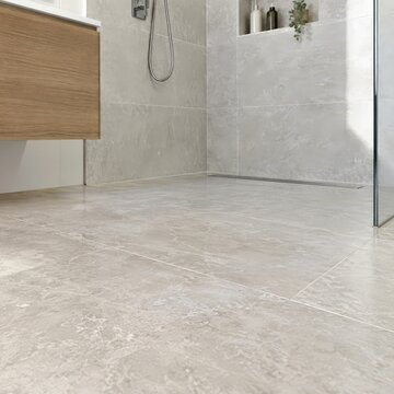 Low view of a bathroom floor that connects to the shower area