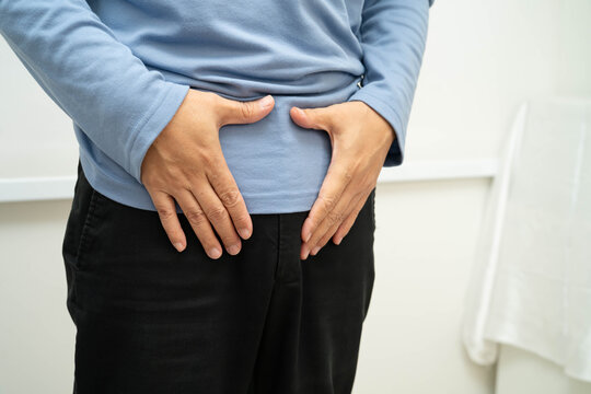 Hernia, Asian man stomach ache, abdominal pain and urology problem health.