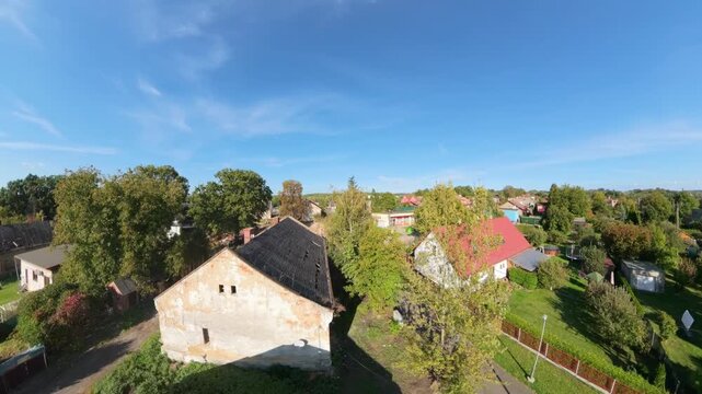 FPV drone reveals a row of former mine workers' cottages with bare roofs awaiting demolition in Hranečn&iacute;k, Ostrava, Czech Republic.