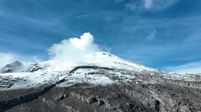 Nevado del Ruiz Snow Covered Volcanic Summit in the Colombian Andes. Establishing Shot. Aerial View.