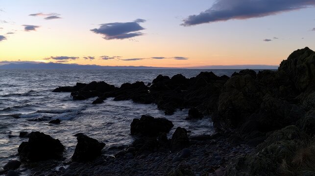 Rocky Coastline at Sunset with Ocean and Sky