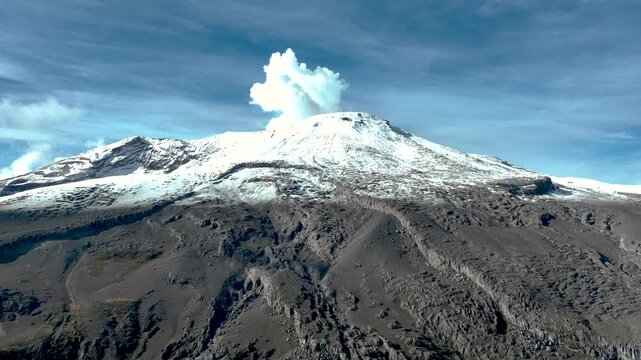 Nevado del Ruiz Snow Covered Volcanic Summit in the Colombian Andes. Establishing Shot. Aerial View.