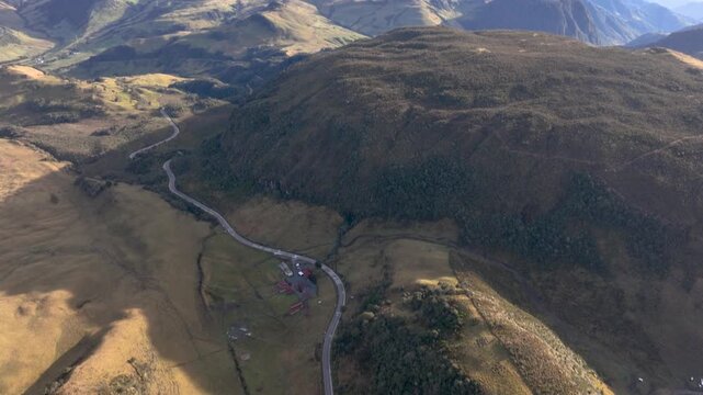 Laguna Negra and Winding Mountain Road near Nevado del Ruiz in Colombia. Establishing Shot. Aerial View.