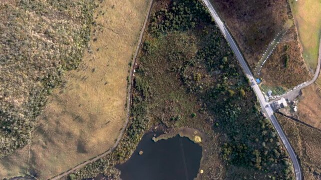 Laguna Negra and Winding Mountain Road near Nevado del Ruiz in Colombia. Establishing Shot. Aerial View.