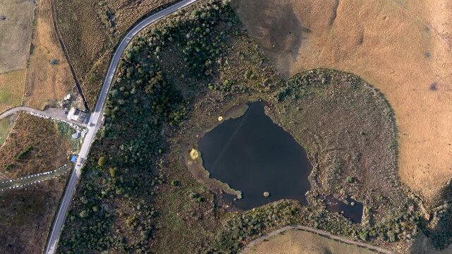 Laguna Negra and Winding Mountain Road near Nevado del Ruiz in Colombia. Establishing Shot. Aerial View.