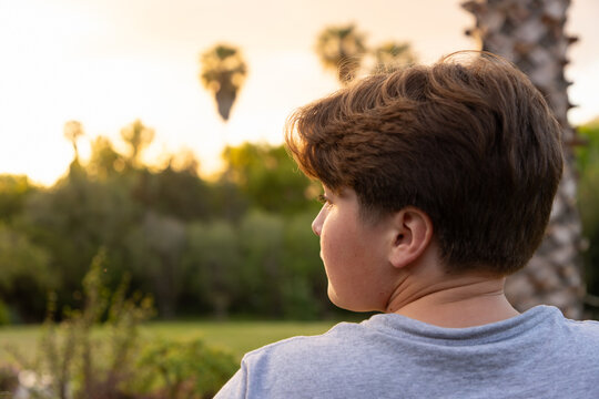 portrait of 13 year old boy at moment of sunset