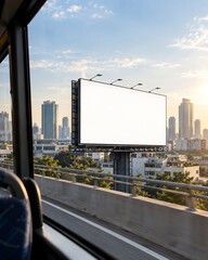 Fototapeta premium A blank billboard stands tall against a city skyline at sunset, viewed from a moving vehicle.