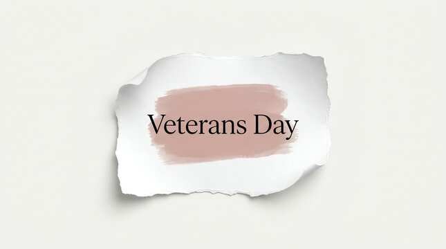 Veterans day text on torn paper piece with a soft pink brush stroke background