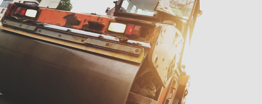 Laying Fresh Asphalt on Urban Streets With a Powerful Paving Roller