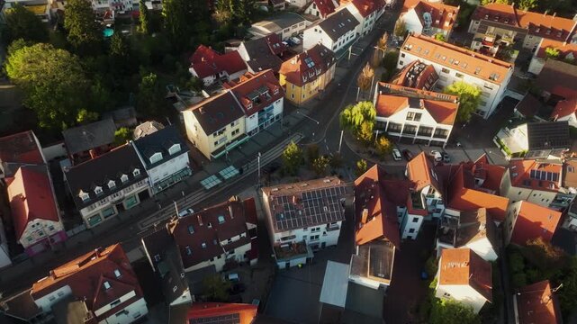 Munich tram stop recedes as the drone rises vertically above the city rooftops.
