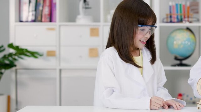 Elementary Student in Lab Coat Working on STEM Engineering Project