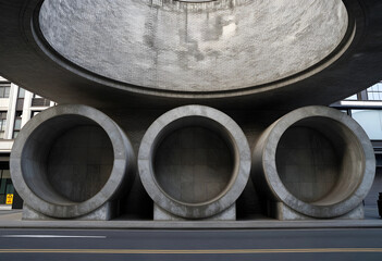 Fototapeta premium Urban infrastructure and modern architecture, concrete tunnel structures in city street with geometric design and brutalist style for metropolitan planning