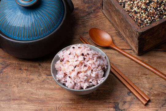 Bowl of cooked multigrain rice on a wooden table