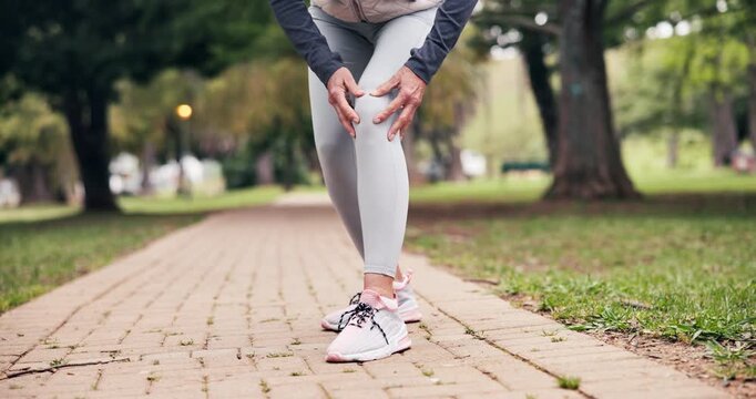Senior, person and hands with knee injury for outdoor discomfort, pain or muscle tension on path. Active, elderly or sore leg with massage for joint inflammation, overworked strain or fibromyalgia
