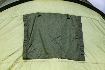 Light green tent with dark green rectangular panel © schankz